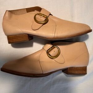 Cream Jeffrey Campbell low top gold buckle heeled booties.